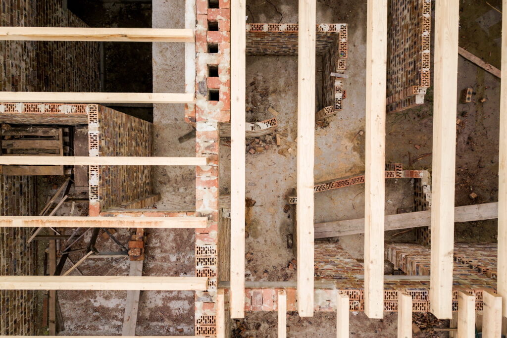 Timeline infographic showing stages of load-bearing wall removal from assessment to finishing