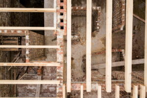 Timeline infographic showing stages of load-bearing wall removal from assessment to finishing